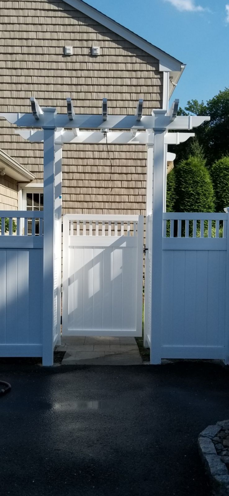 white pergola with gate